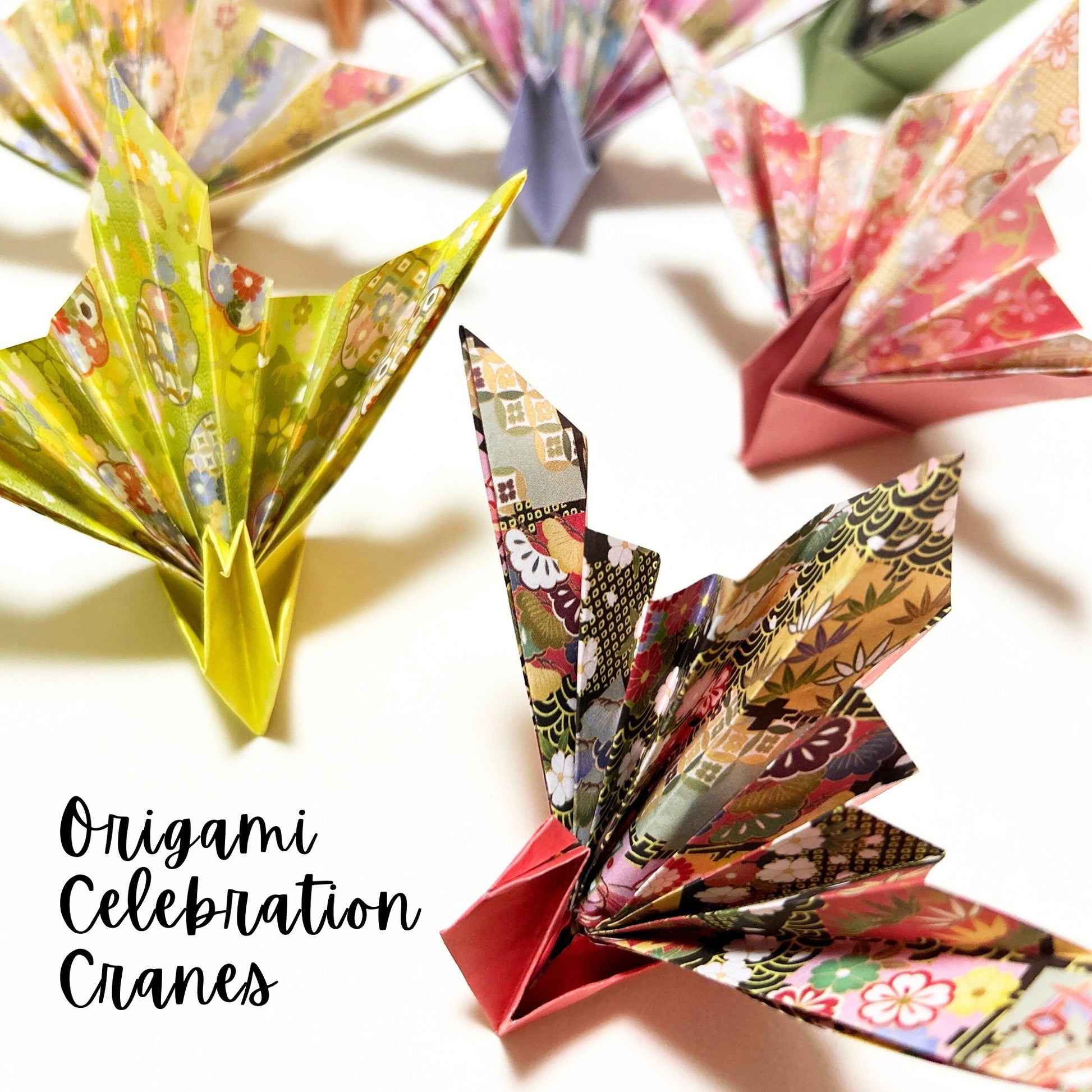 Colorful origami cranes on a light background with 'Origami Celebration Cranes' text.