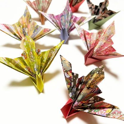 Colorful origami cranes on a white background