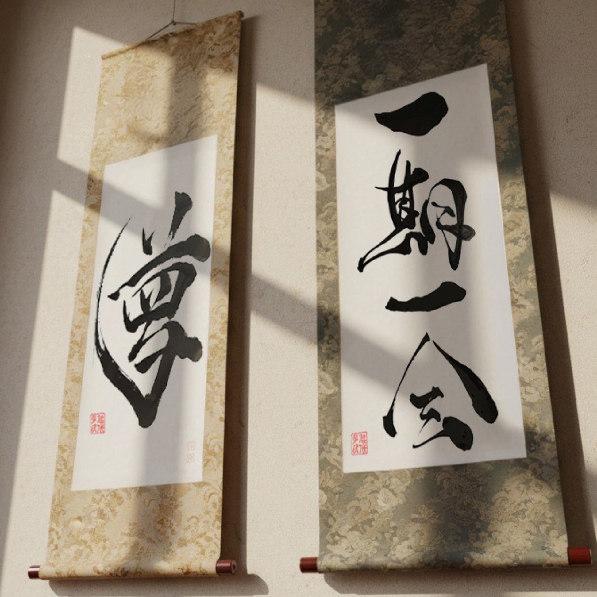 Custom Japanese calligraphy hanging scrolls (Kakejiku) featuring traditional silk silk brocade fabrics and wood rollers. Examples show "Yume" (Dream) and "Ichi-go Ichi-e" (Once-in-a-lifetime encounter), ideal as a personalized Kanji name gift.