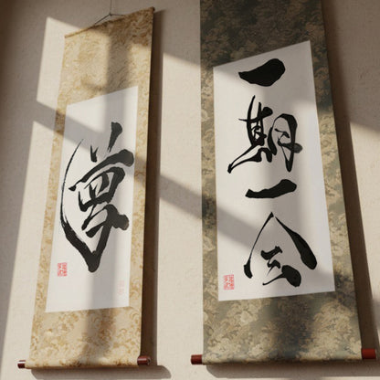 Custom Japanese calligraphy hanging scrolls (Kakejiku) featuring traditional silk silk brocade fabrics and wood rollers. Examples show "Yume" (Dream) and "Ichi-go Ichi-e" (Once-in-a-lifetime encounter), ideal as a personalized Kanji name gift.